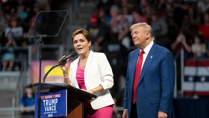 President Donald Trump stands next to Kari Lake on stage during a campaign rally at Findlay Toyota Center on October 13, 2024 in Prescott Valley, Arizona. (Rebecca Noble/Getty Images)